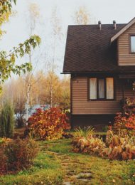 autumn wooden country house and garden view