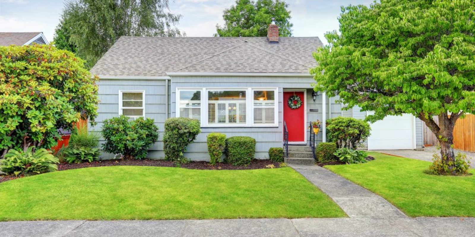 Exterior of small American house with blue paint