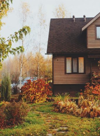 autumn wooden country house and garden view