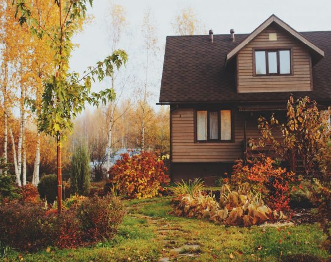 autumn wooden country house and garden view