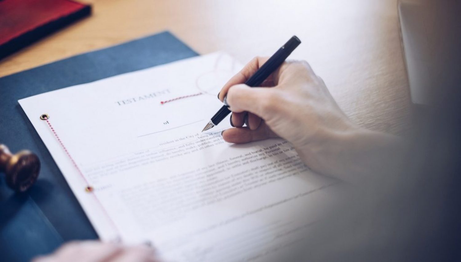 Lawyer working in the office. The document is signed by a female notary.