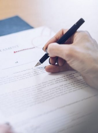 Lawyer working in the office. The document is signed by a female notary.