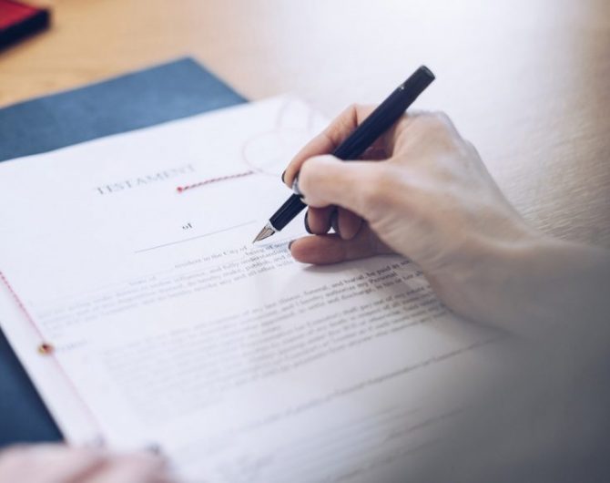 Lawyer working in the office. The document is signed by a female notary.